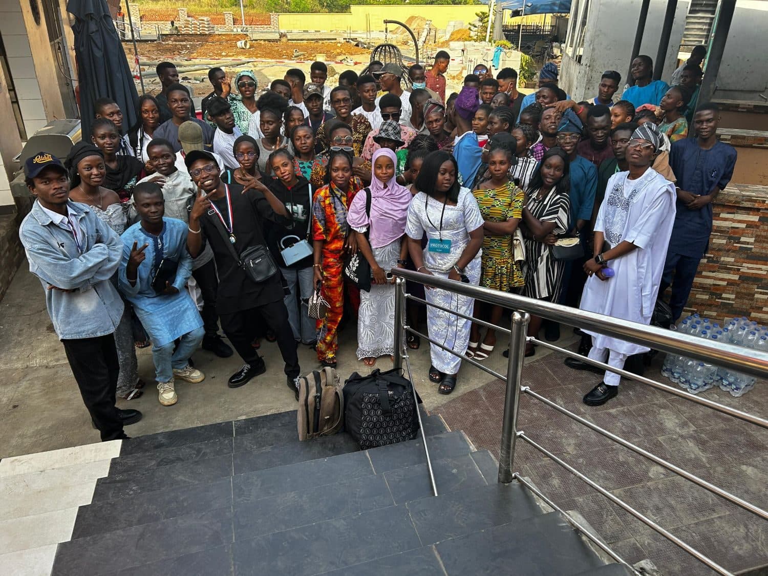 A large group of Accelerator Community members together at the foot of a staircase